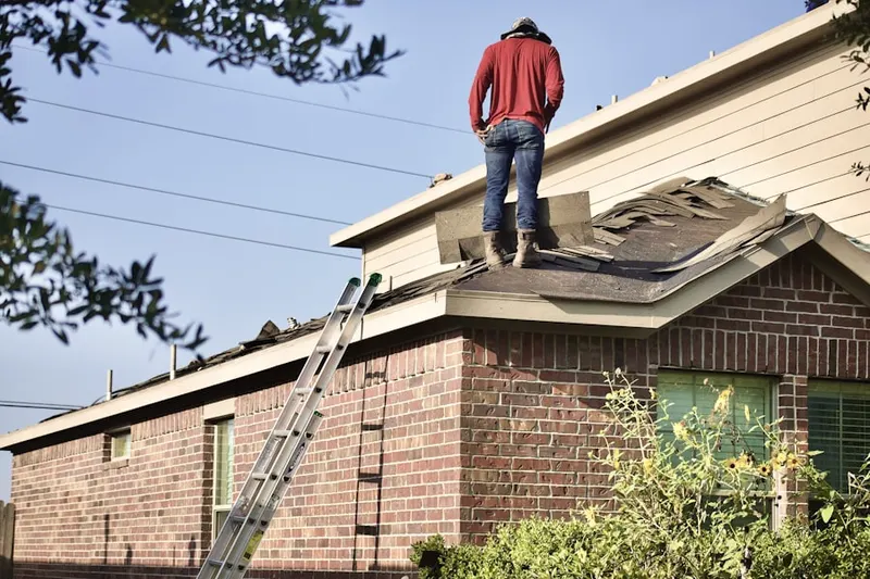 Professional roofer working on a residential roof in North Fayette